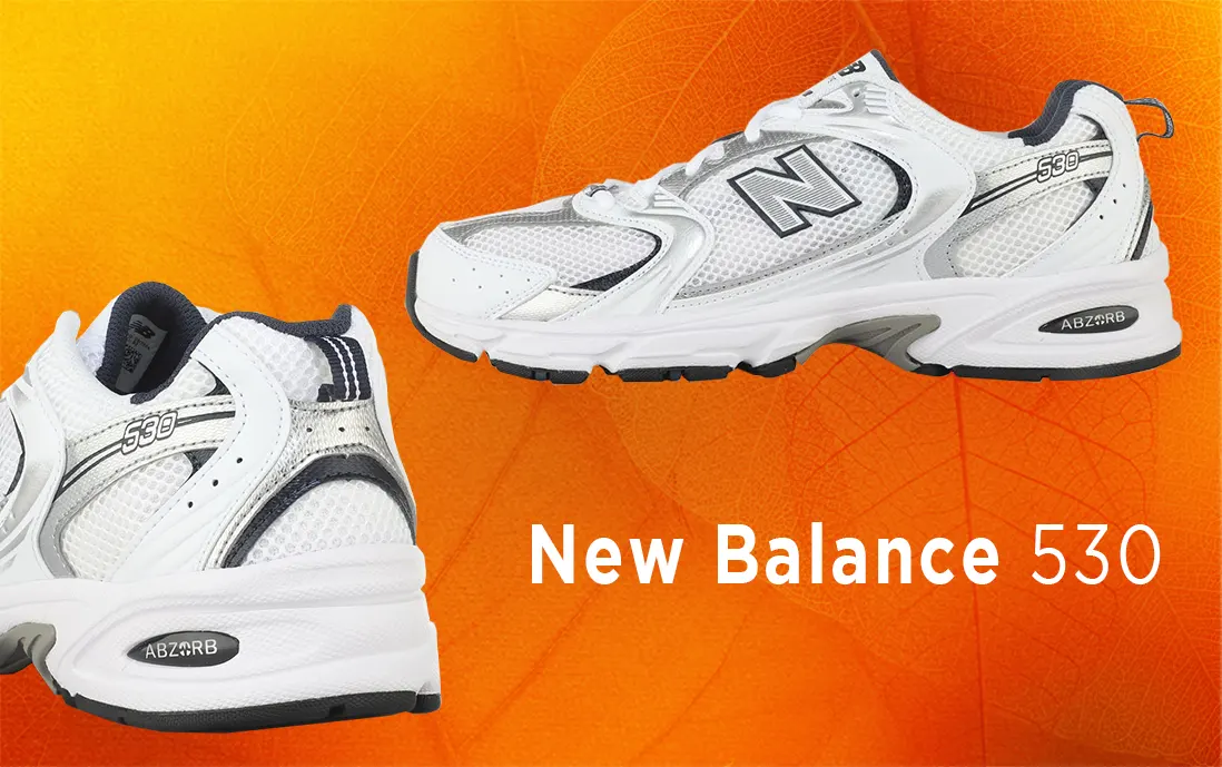 Tenis New Balance 530 con amortiguación, materiales flexibles en color blanco y negro con detalles metálicos.